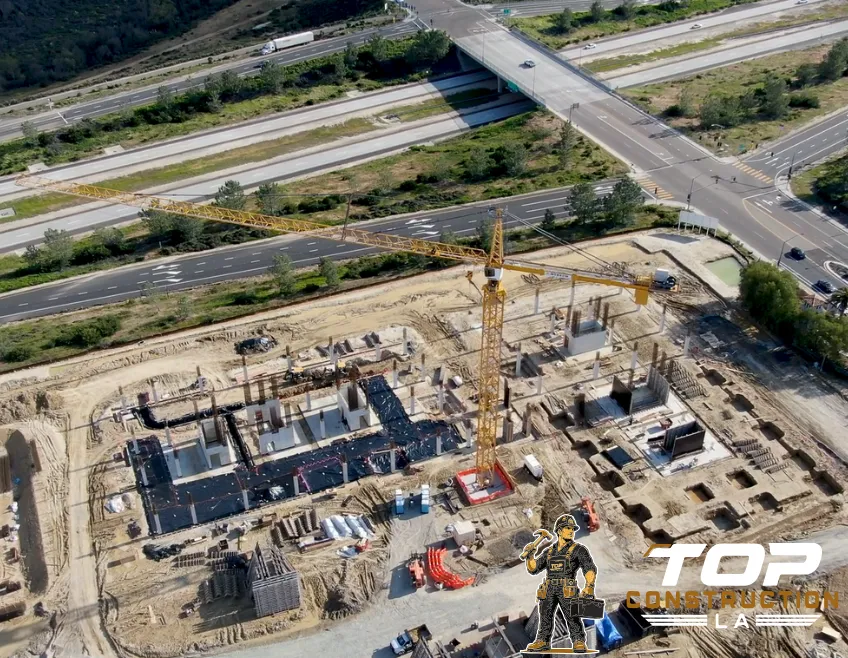 Large commercial construction site in Los Angeles with crane and multi-story steel frame building structure under development